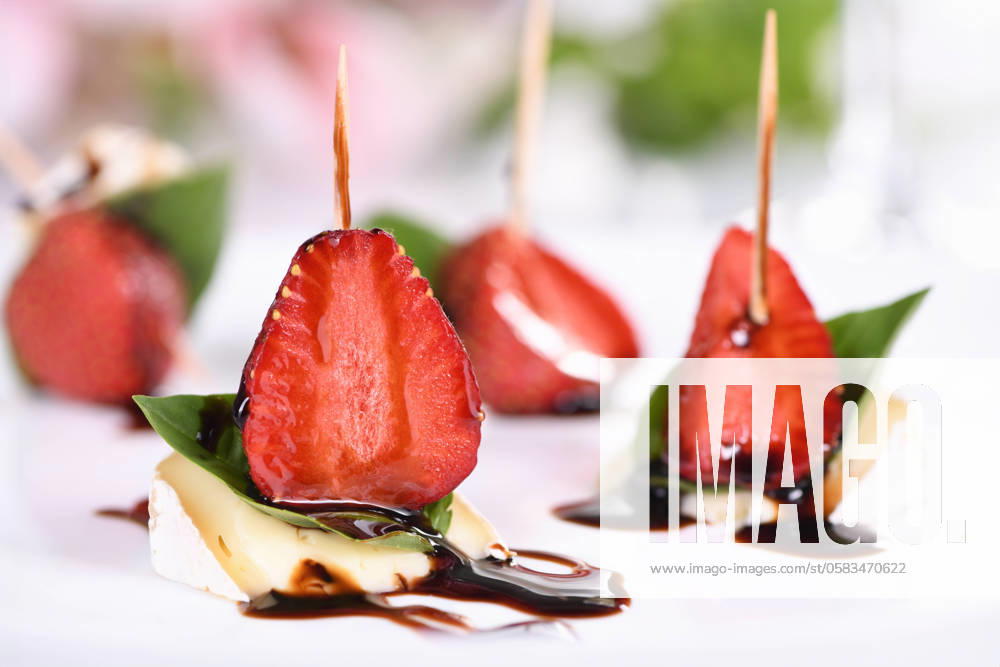 Brie snacks with strawberries and basil Strawberries, cheese, fresh basil and balsamic come together for a bite-sized appetizer