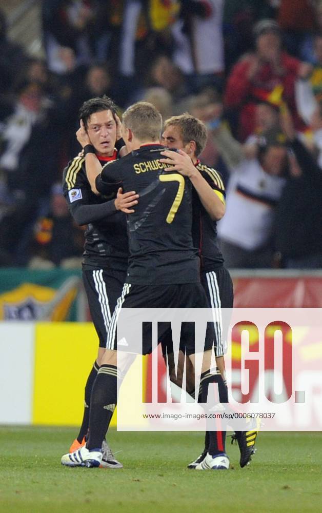 Mesut Oezil of Germany celebrates his goal with Bastian Schweinsteiger (C) and Philipp Lahm (R) - Group D, Ghana vs Germany - .