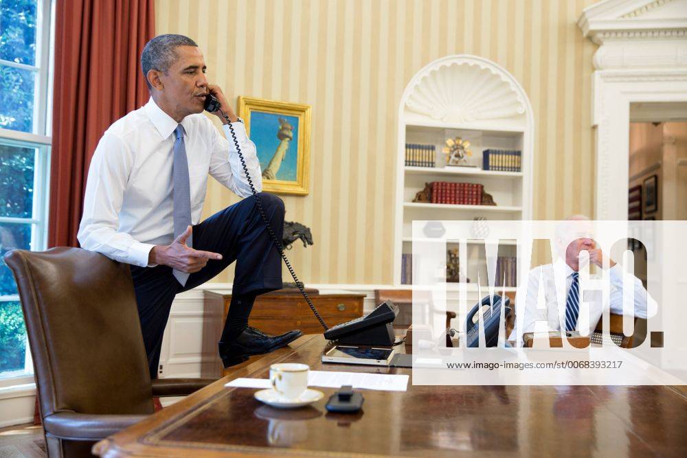 Aug 31, 2013 - Washington, District of Columbia, U.S. - President BARACK OBAMA talks on the phone in the Oval Office with Speaker of the House Boehner Saturday. Vice President JOE BIDEN listens at right. The president delayed military action in Syria Saturday, saying he will seek congressional authorization on the use of force in the wake of a chemical attack said to have left some 1,400 civilians dead. Congressional approval could prove difficult, as members of both parties and many in the public have expressed uneasiness with the idea of a military campaign. - ZUMAz03