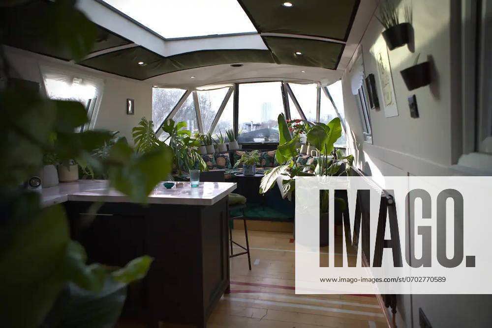Love plants? Stay in Londons first live-in terrarium boat this summer Story from Jam Press (Terrarium Boat) Pictured: The living room. Love plants? Stay in Londons first live-in terrarium boat this summer Are you a plant lover? A water babe? Well, now you can take both to the next level with a stay on a ˜terrarium boat . Moored on a canal in Hackney, London, this life-size ecosystem is made for those who want to get close to nature. The 48.3 sq m boat is decked out with 150 verdant houseplants - making it a perfect live-in oasis. Terrariums are more commonly known to be small, sometimes big, glass enclosures filled with plants, stones and mosses. But this one is a floating, green sanctuary. The two-guest property is co