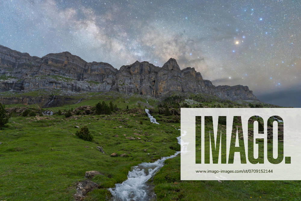 MR_ID22586_17761_JuanLopez.jpg A stunning nighttime view of the Milky Way galaxy shining over the rugged cliffs and a serene flowing stream in Pueblo de Sotres, Asturias, Spain. Perfect for illustrating natural beauty and tranquility. Model Released JuanLopez_ID22586_658771_002