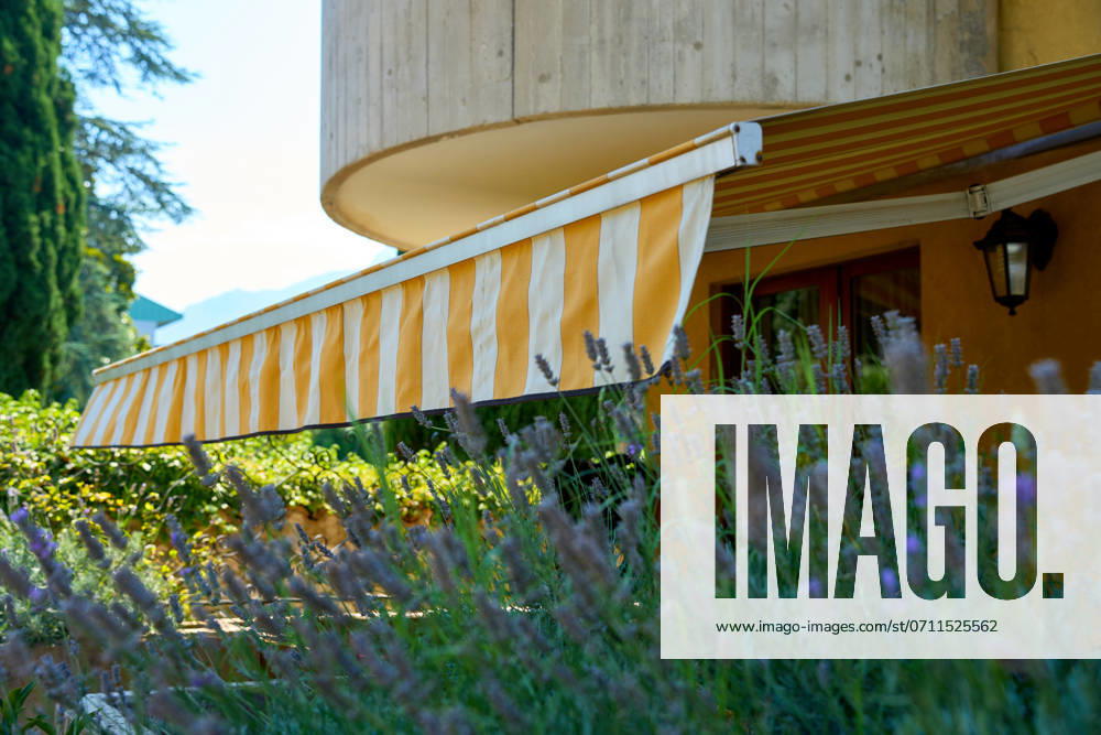 Nago-Torbole, Lake Garda, Italy - 15 July 2024: Awning on a vacation apartment on Lake Garda offers optimum sun protection and increases outdoor living comfort. Awning provides pleasant shade and a cozy ambience on the terrace in Italy