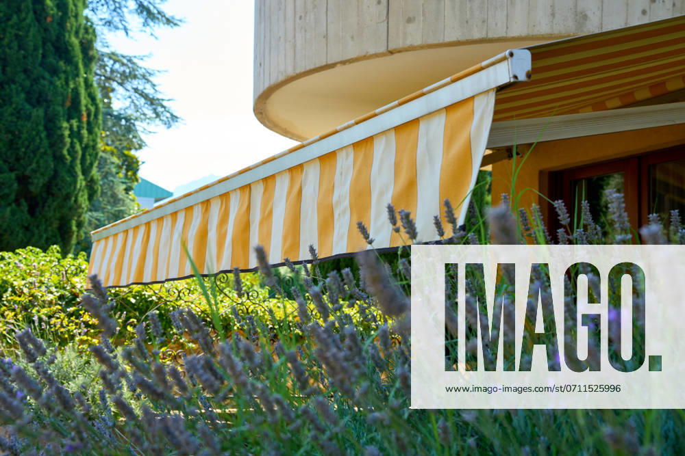 Nago-Torbole, Lake Garda, Italy - 15 July 2024: Awning on a vacation apartment on Lake Garda offers optimum sun protection and increases outdoor living comfort. Awning provides pleasant shade and a cozy ambience on the terrace in Italy