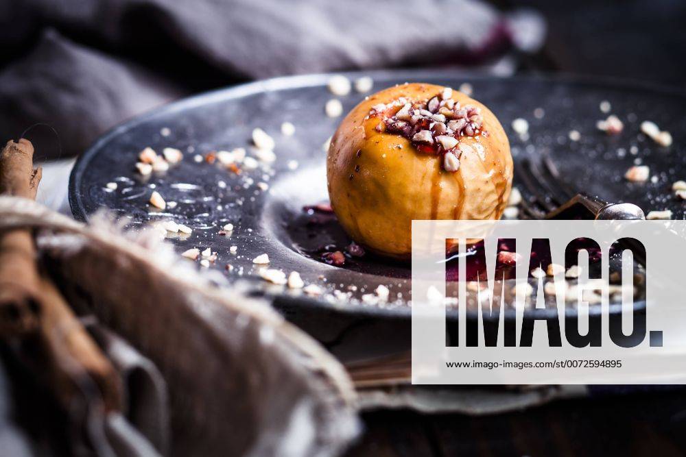 Baked apple with nut- and red jam filling on tin plate SBDF002954