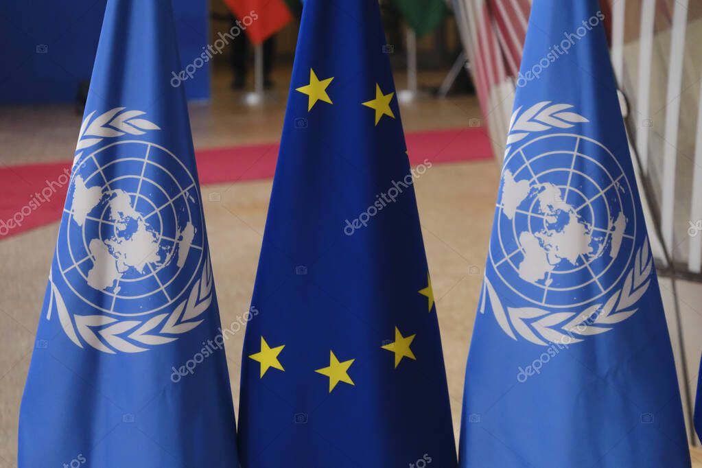 Flags of UN and EU stand in European council Building in Brussels, Belgium on March 23, 2023.