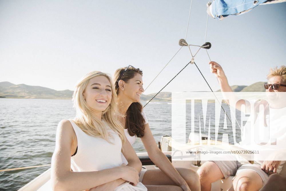 Man, woman and their blond teenage daughter on a sail boat. Man, woman and their blond teenage daughter on a sail boat. 25306