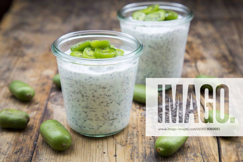 Two glasses of natural yoghurt with chia seeds and slices of hardy kiwis LVF05465