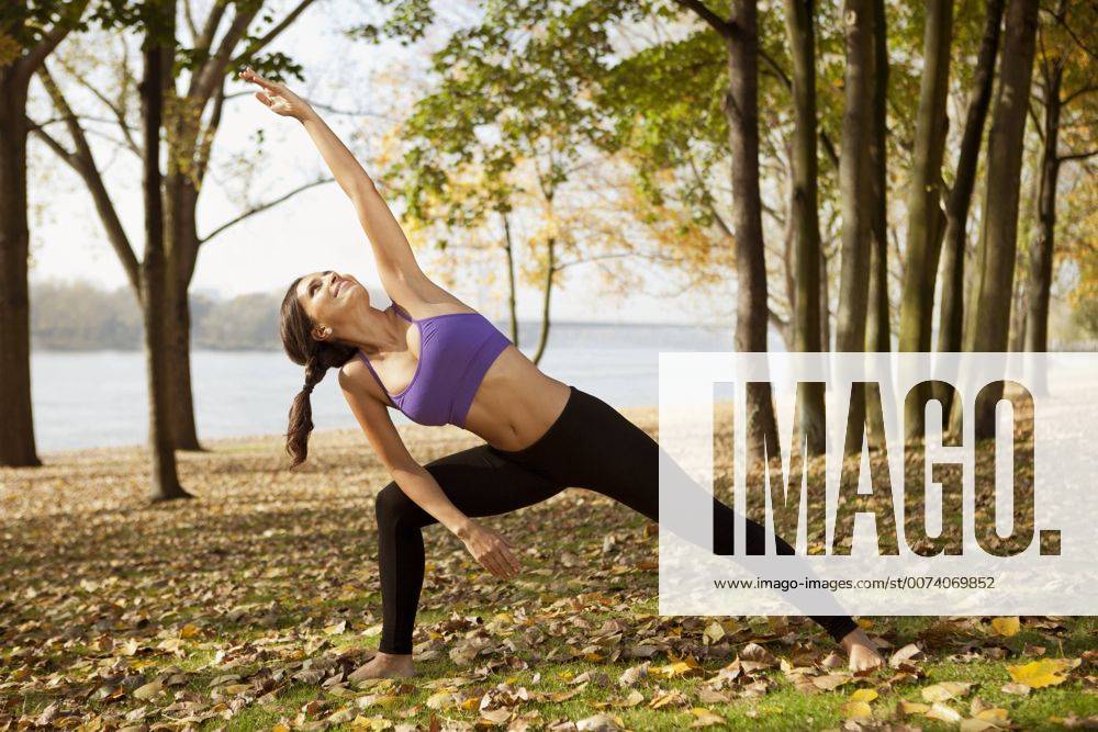 Woman in nature holding a yoga pose model released Symbolfoto MFF003046