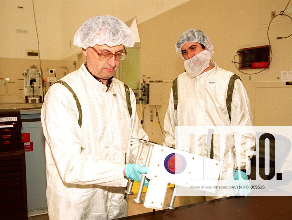 Two Russian scientists look over the High Energy Neutron Detector (HEND), part of the Gamma Ray Spectrometer (GRS), after its removal from the 2001 Mars Odyssey Orbiter. The HEND was built by Russias Space Research Institute (IKI). The GRS will achieve global mapping of the elemental composition of the surface and determine the abundance of hydrogen in the shallow subsurface. The orbiter will carry two other science instruments THEMIS and the Mars Radiation Environment Experiment (MARIE). THEMIS will map the mineralogy and morphology of the Martian surface using a high-resolution camera and a thermal infrared imaging spectrometer. The MARIE will characterize aspects of the near-space radiation environment with regards to the radiation-re