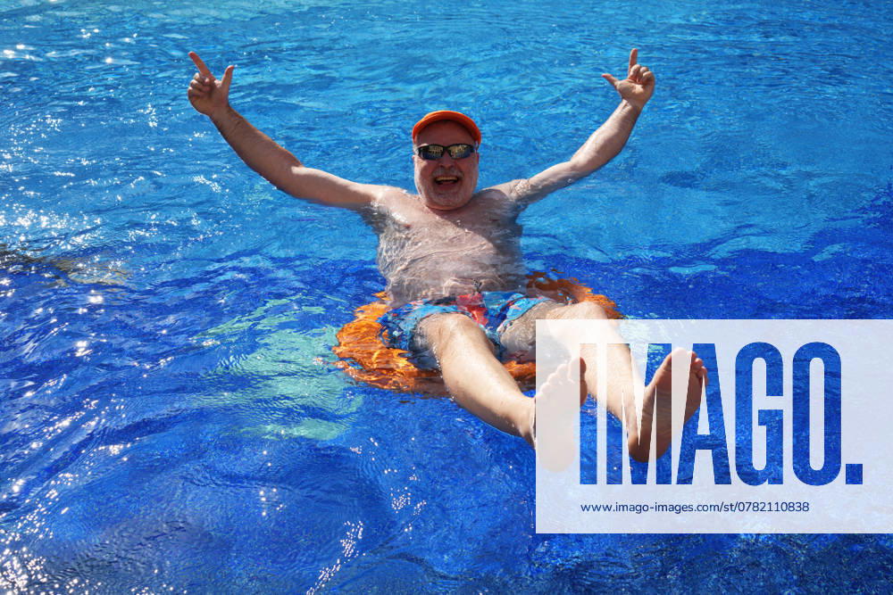 Swimming in swimming pool model release available Egypt, 20241124, senior in swimming pool bathing, health conscious older man M:RY