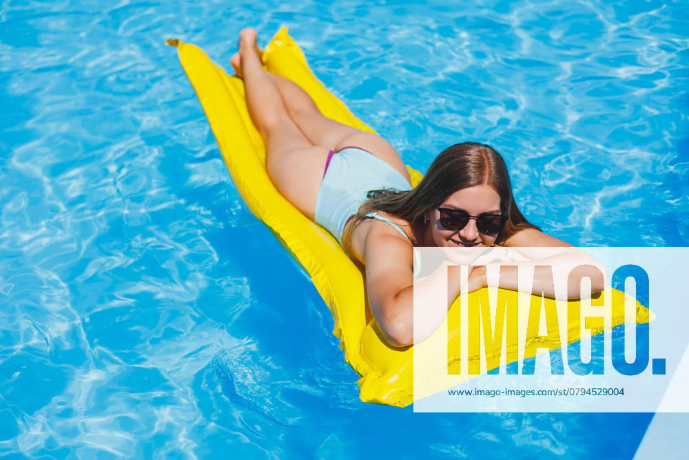 Summer lifestyle portrait of beautiful woman in sunglasses floating on inflatable mattress in outdoor swimming pool. Summer vacation on a tropical island., model released, , 47655908.jpg, summer, beautiful, travel, swimsuit, sexy, inflatable, yellow, summertime, sunglasses, leisure, female, girl, body, sunny, water, swimming, mattress, hot, relax, blue, tanning, tan, pool, holiday, woman, sunbathing, vacation, fashion, recreation, bikini, bed, happy, young, air, view, top, belly, lifestyle, slim, float, suntan, lying, smiling, legs, model, enjoy, green, concept, beauty, space RECORD DATE NOT STATED