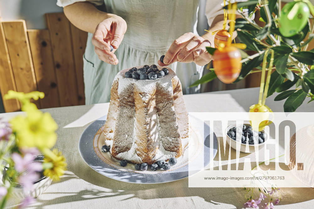Woman decorating Pandoro bread with blueberries model released, Symbolfoto property released, CATF00575