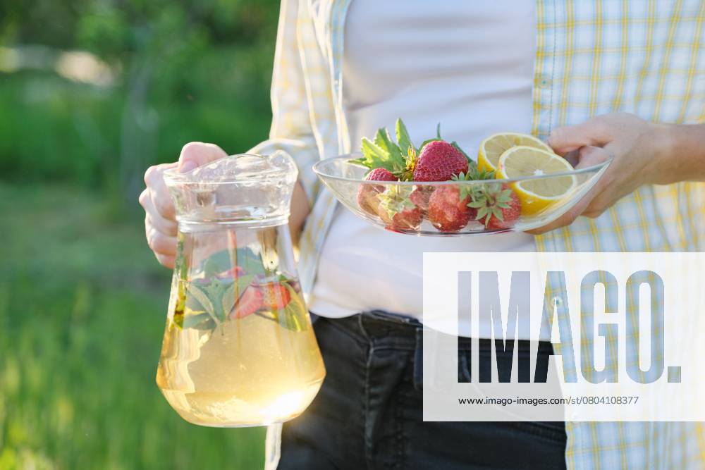 Spring summer refreshments, woman in nature holding jar of strawberry mint and lemon., model released, , 50700690.jpg, mint, lemon, strawberries, glass, drink, beverage, woman, hands, ice, green, strawberry, food, sweet, cold, cocktail, summer, juice, ingredient, red, fresh, water, refreshment, freshness, leaf, citrus, lemonade, berry, healthy, cool, liquid, background, slice, refreshing, closeup, herb, vitamin, white, straw, organic, gin, homemade, tea, vegetarian, rustic, antioxidant, herbal, spring, seasonal, fruit RECORD DATE NOT STATED