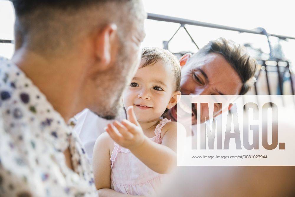 Happy gay couple with daughter on balcony model released Symbolfoto property released MRAF00248