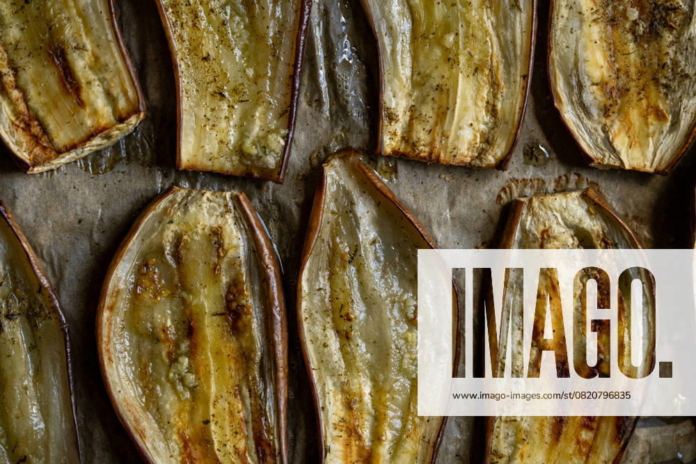 Close-up of oven-roasted eggplant slices, perfectly baked for a healthy vegetarian meal. The rich texture and rustic look highlight Mediterranean cuisine s essence Model Released Ellsy_ID29115_889272_005