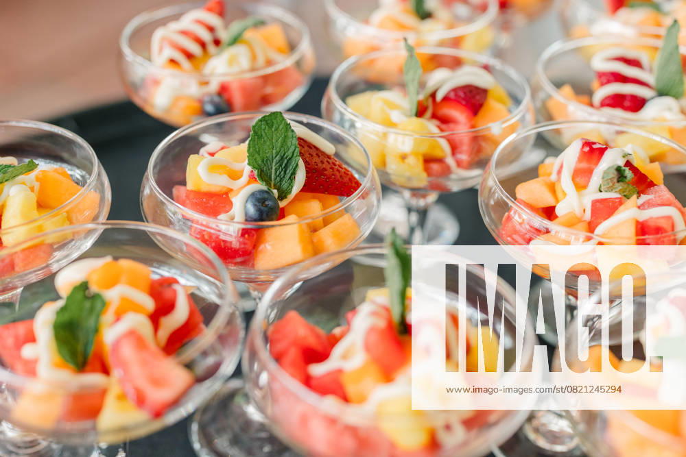 Fruit salad cups with yogurt drizzle and mint garnish Pittsburgh, Pennsylvania, United States R_QIWH250529-1745897-01