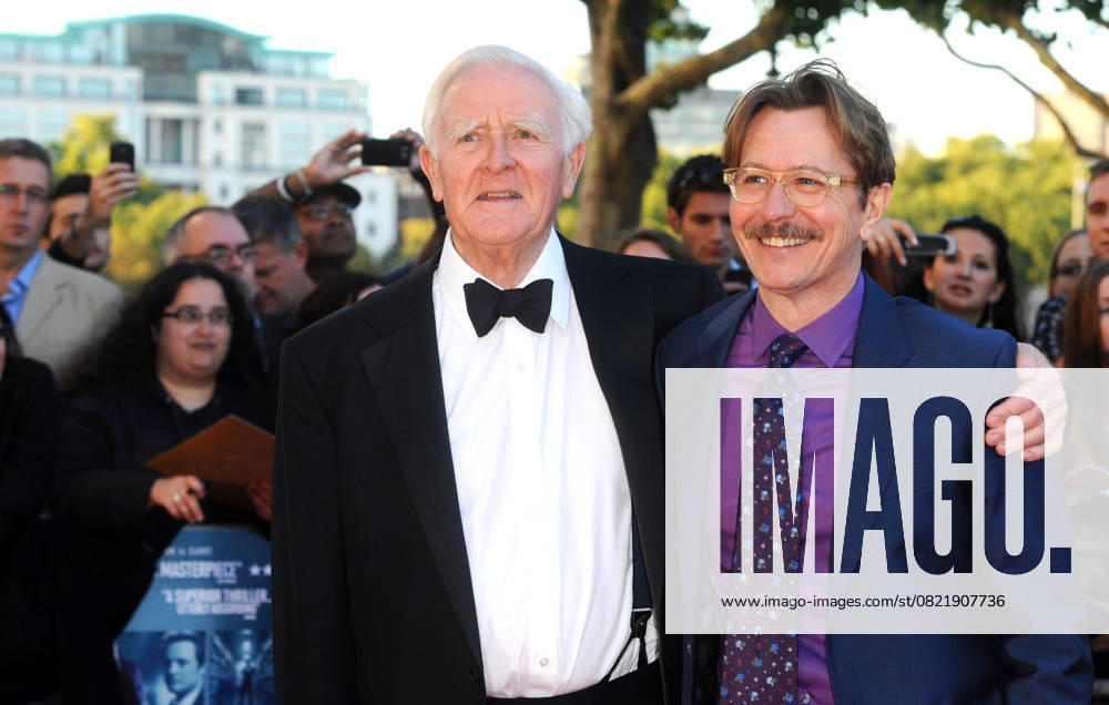 The Tinker, Tailor, Soldier, Spy UK premiere JOHN LE CARRE & GARY OLDMAN The Tinker, Tailor, Soldier, Spy UK premiere, BFI Southbank cinema, Belvedere Rd., London, England. September 13th, 2011 half length black suit moustache mustache facial hair tuxedo pink shirt blue CAP CJ Chris Joseph London Great Britain