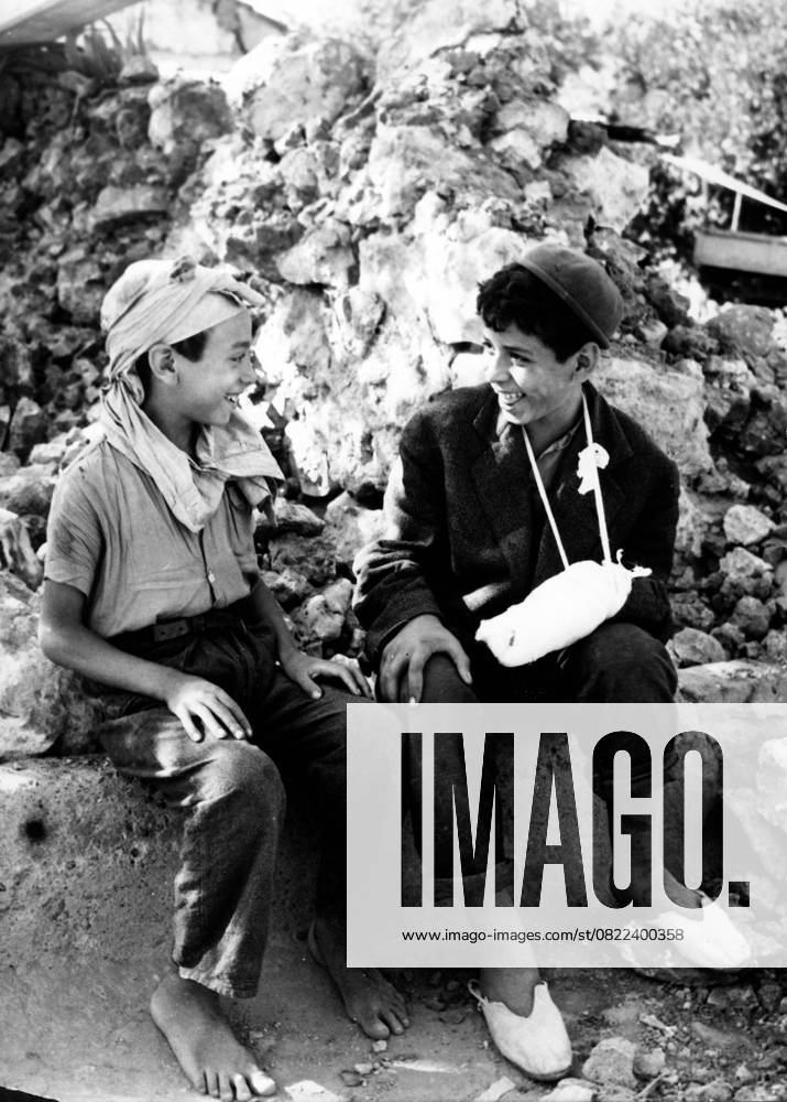 Natural disasters Earthquake 1954 in Algeria 14 September 1954 Orleansville, Algeria Two Boy Arabic Boys, Survivors the Tragedy, smile in the Ruins their House to the Earthquake at September 1954 in Algeria at the Catastrophe in the African Country Kamen 1 400 People ums Life, 14 000 were violated Ville Orleans Algeria