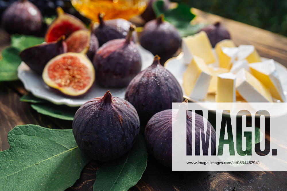 Cheese platter with camembert brie, healthy juicy organic figs, honey and grapes Cheese platter with camembert brie, healthy juicy organic figs, honey and grapes. Red wine glass, appetizer set. Seasonal fruits, 96035500.jpg RECORD DATE NOT STATED
