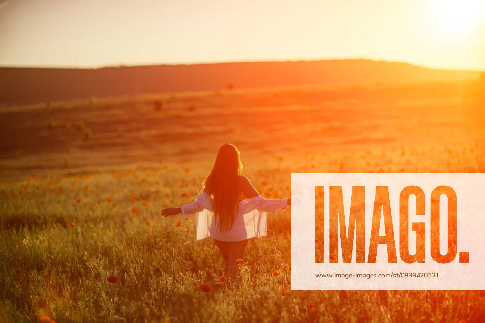 A woman is standing in a field of flowers, with the sun shining brightly on her. Concept of peace and tranquility, as the woman is enjoying the beauty of nature. A woman is standing in a field of flowers, with the sun shining brightly on her. Concept of peace and tranquility, as the woman is enjoying the beauty of nature, model released, , 59340660.jpg RECORD DATE NOT STATED