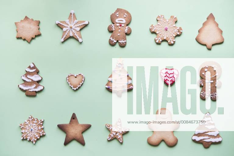 Rows of various gingerbread decorated with sugar icing on bright green ground SKCF00461