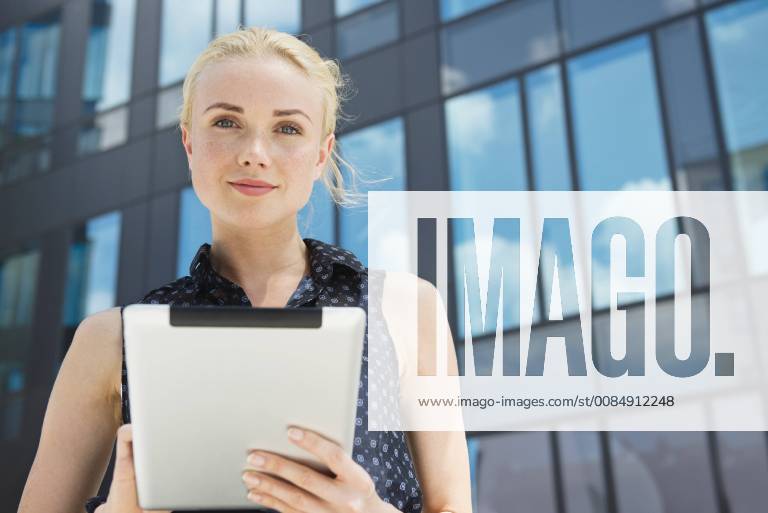 Young businesswoman using digital tablet outdoors