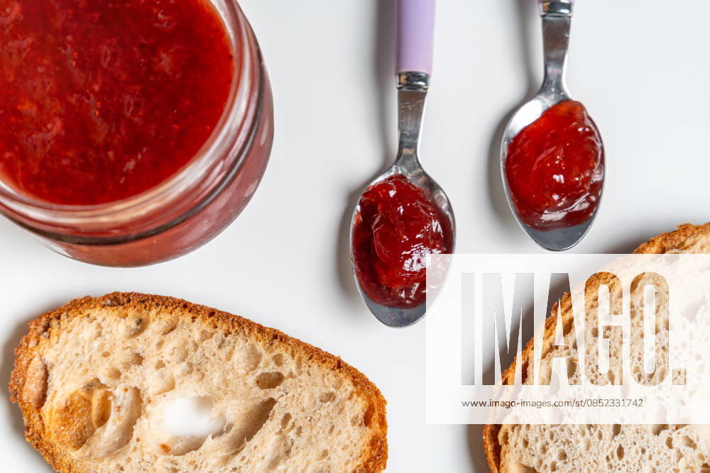 Bavaria, Germany March 31, 2026: Fresh jam is spread on bread with a spoon, symbolizing a classic breakfast where enjoyment, simple ingredients, and a sweet start to the day are at the heart of daily nutrition.