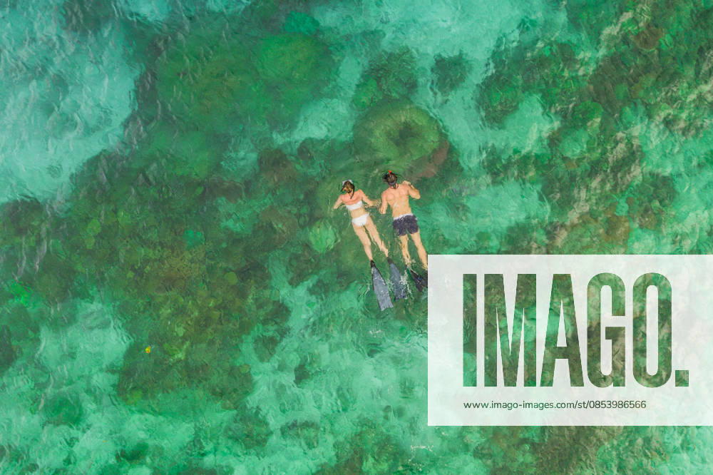 High angle shot of an unrecognizable couple swimming in the waters of Raja Ampat. (License=RF) ,model released, Symbolfoto