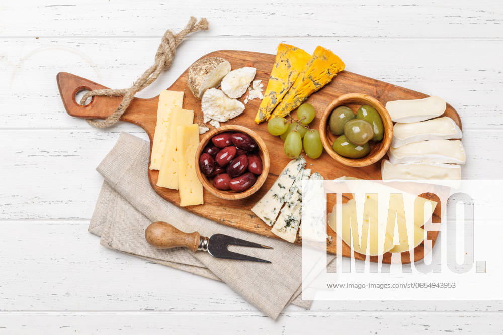 Käseplatte mit verschiedenen Käsesorten und Oliven Cheese board with assorted cheeses and olives, gourmet appetizer perfect for wine tasting and gatherings (License=RF)