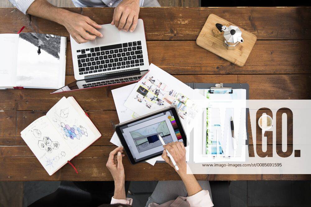Mature couple working from their home office, using laptop and digital tablet model released Symbolfoto property released FKF03074
