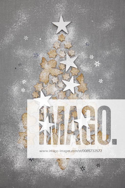 Christmas cookies and white stars forming Christmas Ttee on grey background GWF05618