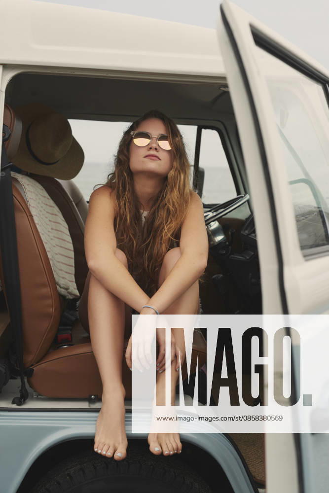 Woman, relax and car at beach for road trip with travel, sunglasses or break on holiday for summer getaway. Girl, vehicle and transportation with shades, pride and confidence on vacation with tourism. model released property released