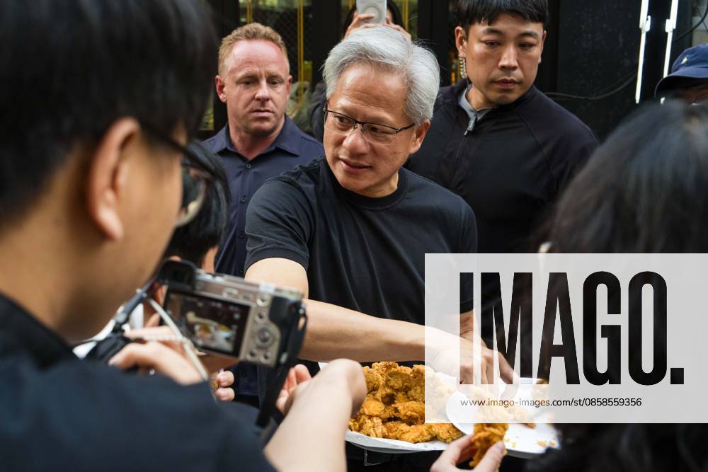Nvidia founder and CEO JENSEN HUANG hands out fried chicken to members of the media as he eats and drinks beer with SK Group chairman Chey Tae-won at Kkanbu Chicken, during HuangÃ¢â‚¬â ¢s visit to Seoul, South Korea on Sunday, June 7, 2026. Seoul South Korea - ZUMAh163 20260607_znp_h163_004