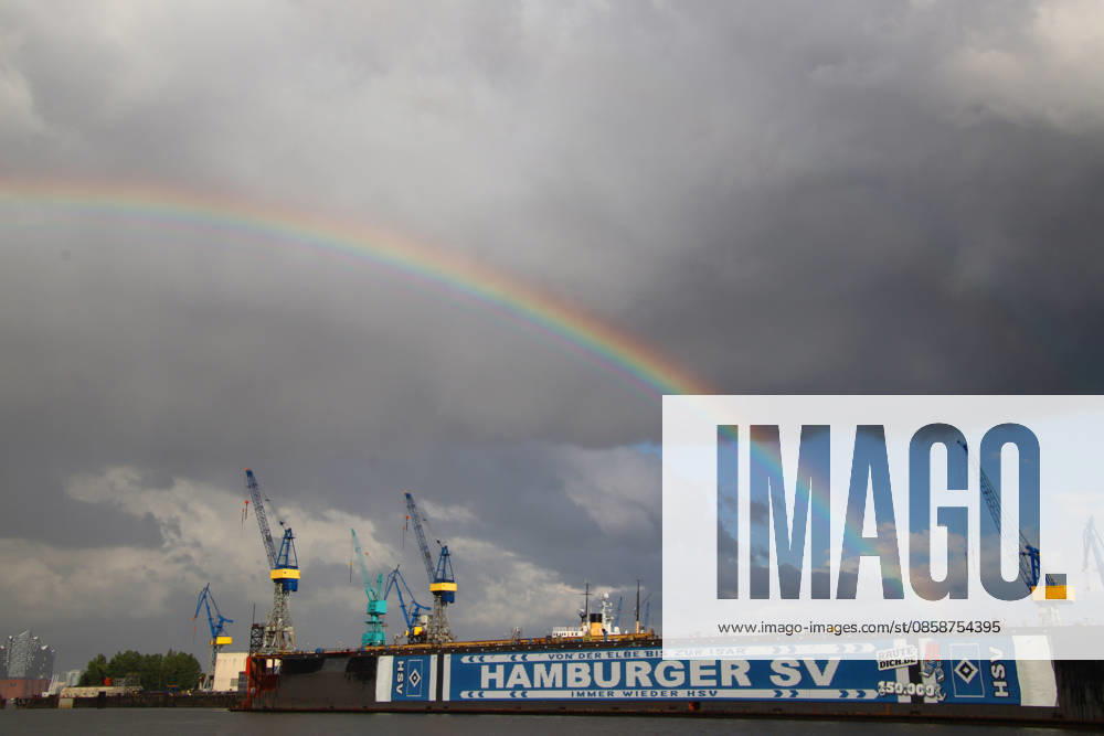 After a thunderstorm, a rainbow appears over the port of Hamburg