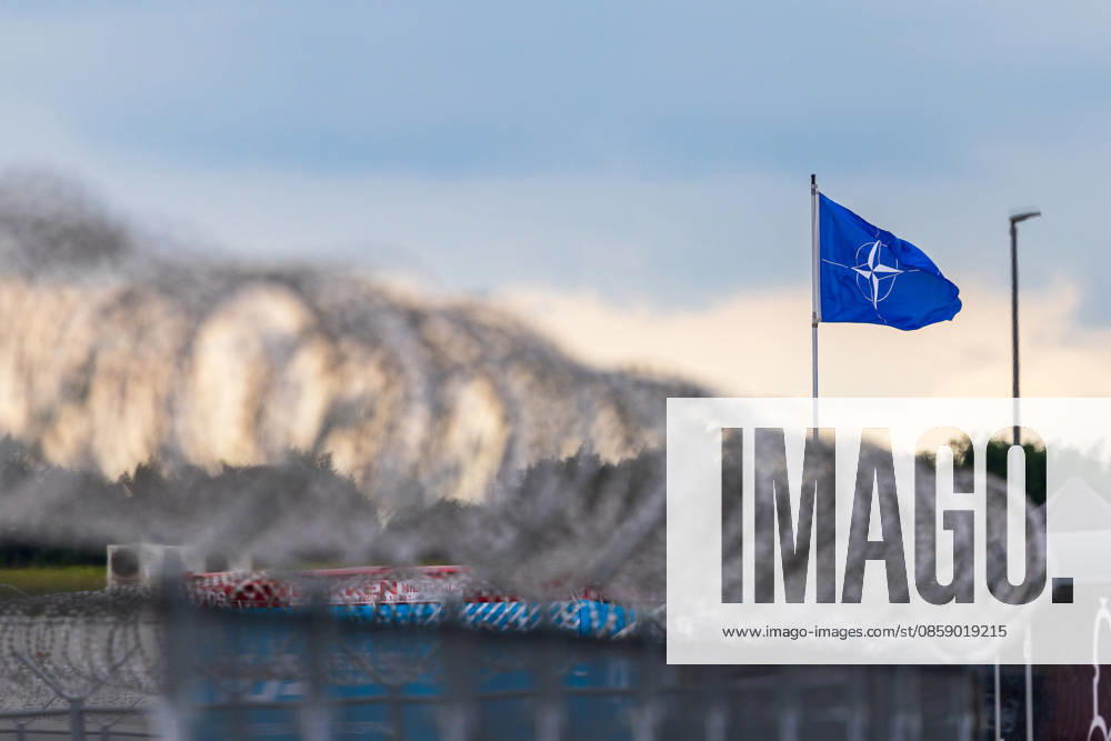 Trade visitor day at ILA Berlin 2026, Berlin, 12 06 2026 A NATO flag flies in the wind behind a barbed wire barrier Concrete barriers with red and white markings can be seen in the foreground Schöneberg Berlin ExpoCenter Airport Brandenburg Germany 20260612-1V9A1902-M4000