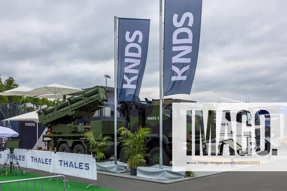 Trade visitor day at ILA Berlin 2026, Berlin, 12 06 2026 The MARS 3 multiple rocket launcher system from KNDS is on display in the outdoor area of the exhibition grounds KNDS is also presenting another vehicle and a truck Barriers with Thales lettering can be seen in the foreground Schöneberg Berlin ExpoCenter Airport Brandenburg Germany 20260612-286A9961-M4000
