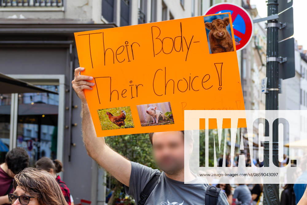 Augsburg, Bavaria, Germany June 13, 2026: Christopher Street Day (CSD) in Augsburg. The parade through the city center promotes the rights of LGBTQ+ people as well as social diversity and tolerance. One participant promotes veganism with a poster; he holds a poster featuring photos of animals with the caption: THEIR BODY THEIR CHOICE