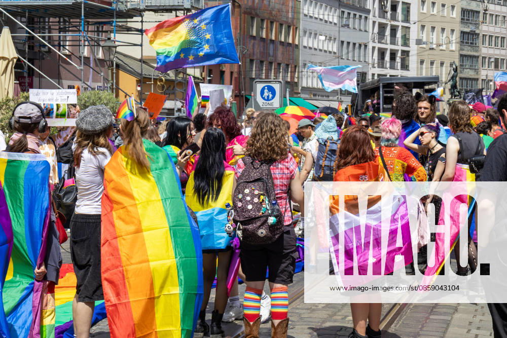 Augsburg, Bavaria, Germany June 13, 2026: Participants carrying rainbow flags and wearing colorful costumes take part in Christopher Street Day (CSD) in Augsburg. The parade through the city center promotes the rights of LGBTQ+ people as well as social diversity and tolerance. Several participants carry various Pride and identity flags