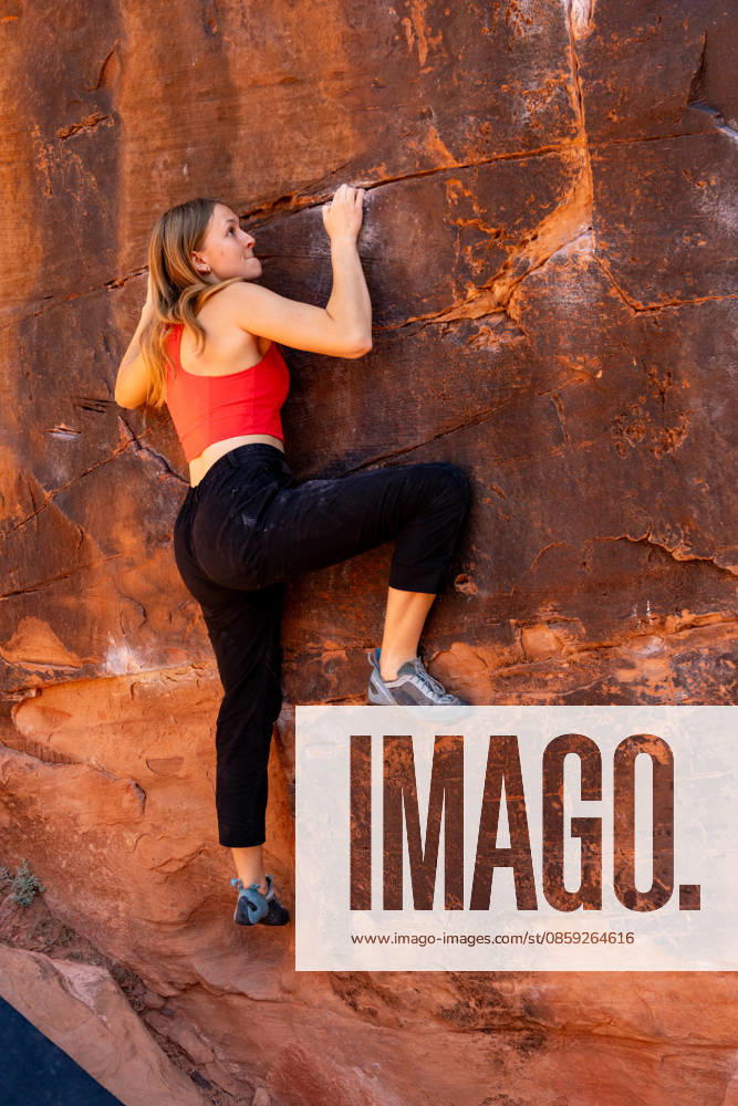 A young female climber bouldering on the Black Box, Big Bend Bouldering Area near Moab, Utah. Moab Big Bend Bouldering Area Utah United States