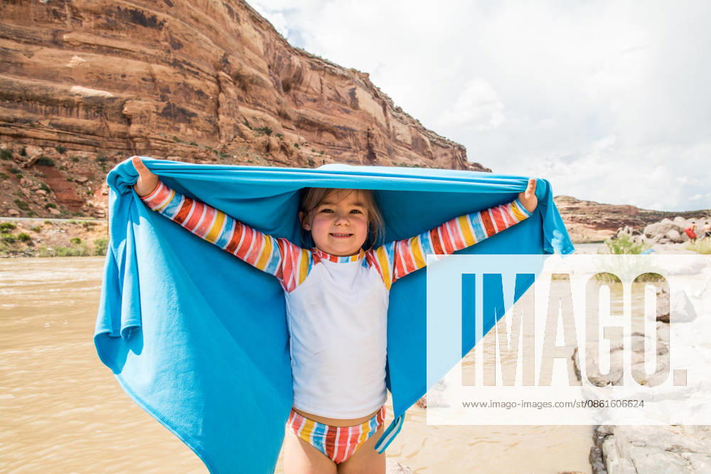 Happy little girl holding up a towel by a river Moab, Utah, United States CR_JDIP260712B-2073104-01 ,model released, Symbolfoto ,property released