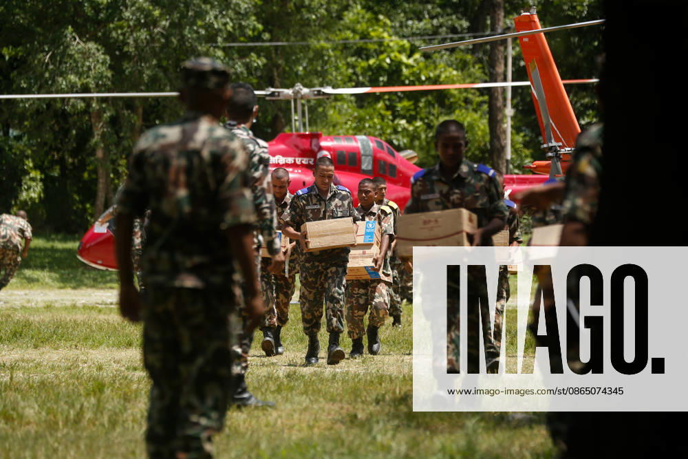Nepal Disaster: The Second Day Of Devastation, Rescue And Recovery Security personnel unload relief supplies from a helicopter in Nuwakot, Nepal, on August 27, 2026, following an outburst of a glacial lake in Tibet. Emergency teams continue rescue and relief operations in flood-affected areas, providing essential supplies to stranded and displaced residents. Nuwakot Nepal