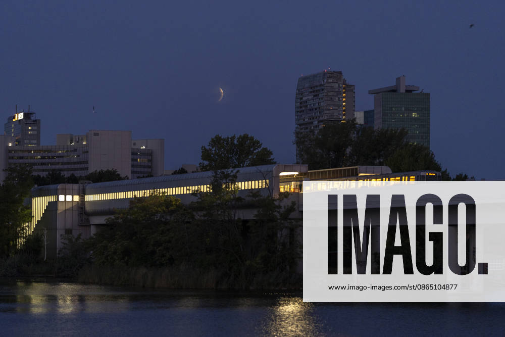 Moon during partial eclipse seen from Austrias capital Vienna, in frame is the subway station Alte Donau. Vienna Vienna Austria