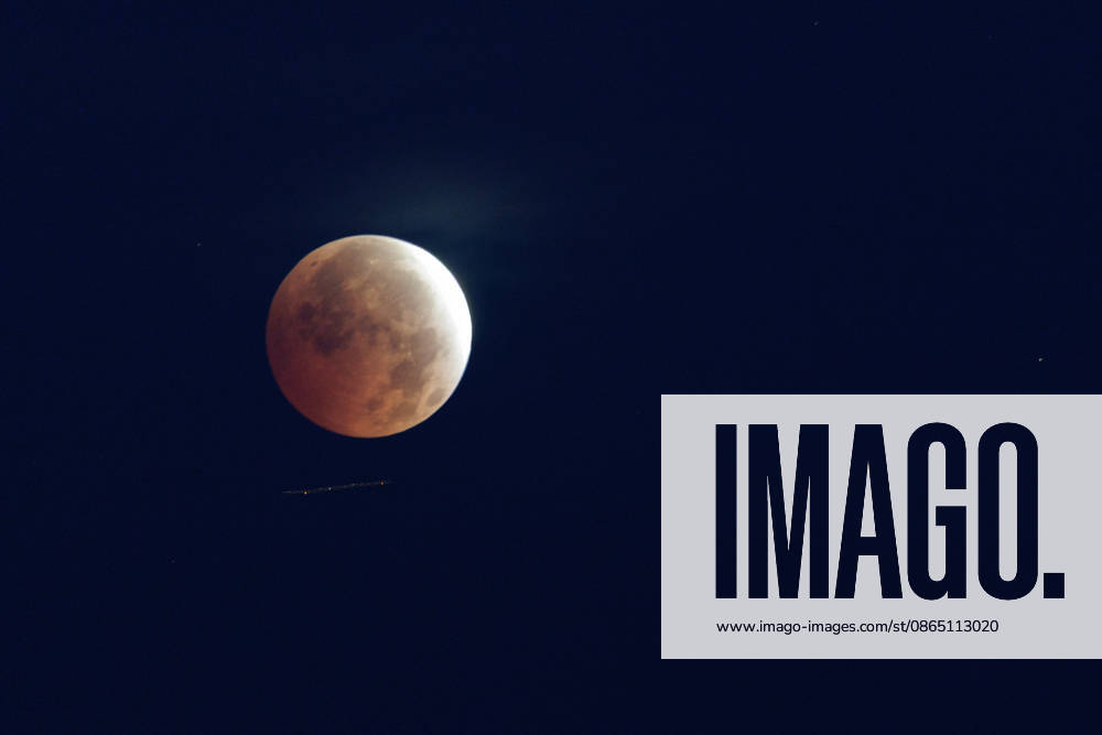 Partial Lunar Eclipse Seen Over Southern France. France - Sete, 28.08.2026 A long time exposure shows an airplane as the Moon appears reddish during a partial lunar eclipse this Friday morning over Sete in southern France. Occitania