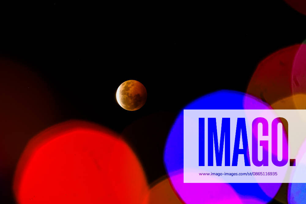 The lunar eclipse seen among colored lights from the city of Valparaiso. Valparaiso Chile - ZUMAs197 20260828_aaa_s197_004