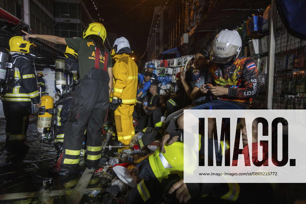Bangkok Fire Engulfs Klongthom Centre Firefighters and rescue workers gather around an exhausted emergency worker seated amid debris inside the market complex at Klongthom Centre on Worachak Road in Pom Prap Sattru Phai, Bangkok, Thailand, on August 28, 2026. The fire was reported at 8:42 p.m. at Klongthom Centre on Worachak Road, where flames spread from a ground-floor shop across the ground floor and mezzanine beneath the parking area; parts of the structure subsided, several emergency personnel were injured, and firefighters brought the blaze under control at about 11:15 p.m. Bangkok Bangkok Thailand