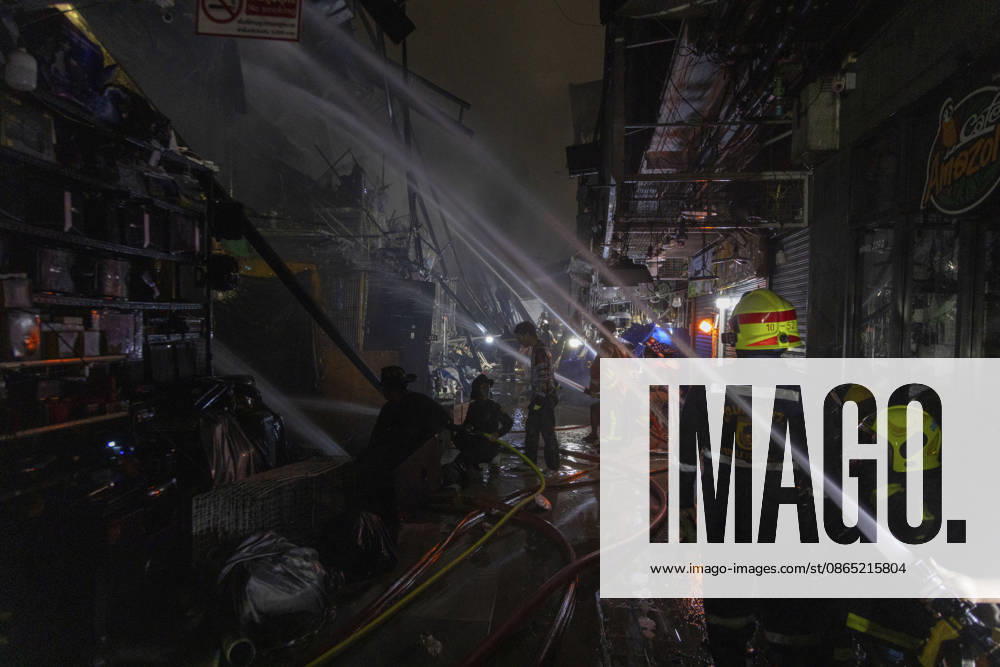 Bangkok Fire Engulfs Klongthom Centre Firefighters direct multiple water streams through a debris-filled passage inside the fire-damaged market complex at Klongthom Centre on Worachak Road in Pom Prap Sattru Phai, Bangkok, Thailand, on August 28, 2026. The fire was reported at 8:42 p.m. at Klongthom Centre on Worachak Road, where flames spread from a ground-floor shop across the ground floor and mezzanine beneath the parking area; parts of the structure subsided, several emergency personnel were injured, and firefighters brought the blaze under control at about 11:15 p.m. Bangkok Bangkok Thailand