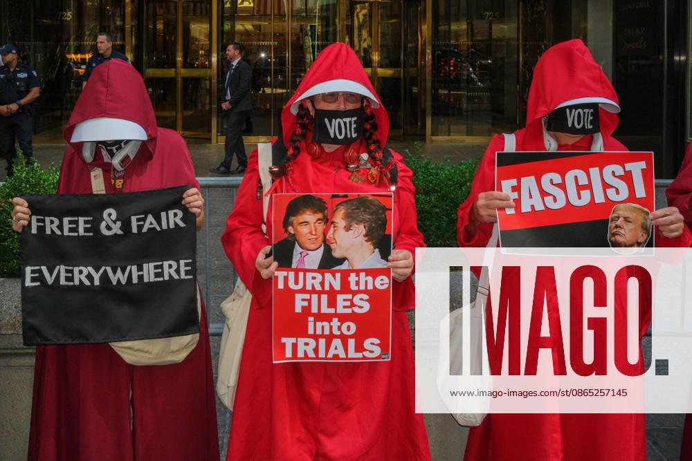 In front of Trump Tower the National Handmaiden Army and their visual imagery in NYC silently protesting.Donald Trump, the lack of womens rights, government policies, reproductive rights, getting out the Vote,.gender discrimination and body autonomy. They are striking symbols of political defiance and solidarity. New York USA - ZUMAh156 20260829_znp_h156_005