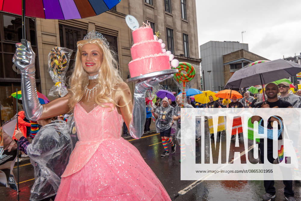 Drag queen carries a cake with an umbrella during the pride parade. Revelers refused to let a heavy downpour dampen their spirits as the annual parade makes its way through the city centre. Despite the torrential rain, the LGBTQ+ community and supporters partied anyway, filling the streets with vibrant colour, music, and joy. The festival has been officially renamed Manchester Village Pride this year, marking a new community-led chapter after the voluntary liquidation and financial collapse of the former organizing company last autumn. Taking part in the celebrations, the newly elected Mayor of Greater Manchester, Bev Craig, actively engaged with parade participants and cheering crowds along the - ZUMAs197 20260829_aaa_s197_373
