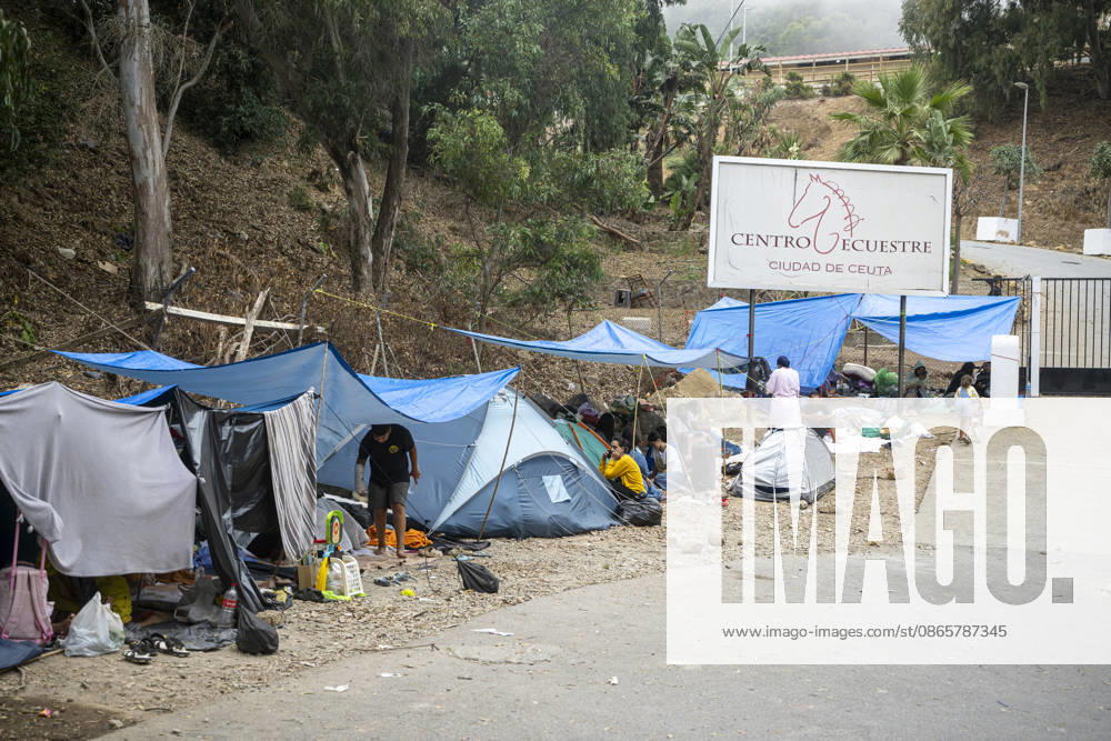 Women and children wait at the gates of La Hípica to be taken in. Migrant families wait at the gates of the La Hípica Equestrian Center in Ceuta on September 3, 2026, in Ceuta, Spain. Dozens of migrant women with their children are waiting in makeshift camps to be housed at the La Hípica Equestrian Center. On August 31, the center began receiving migrant women and girls who had been staying in various temporary settlements throughout the city, as part of the operation launched to dismantle these camps and transfer their occupants to temporary shelter facilities set up by the authorities. SEPTEMBER 3, 2026 PIXELATED MIGRATION CRISIS Ceuta Ceuta, Spain