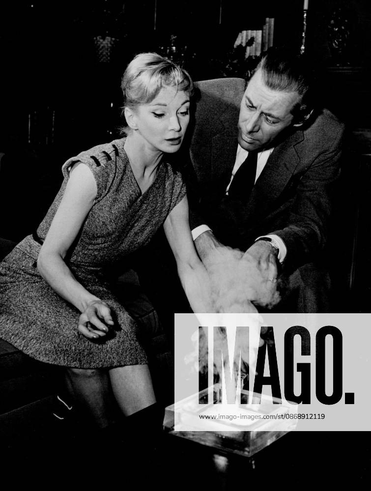 Rex Harrison seems taken aback as Joan gives a small demonstration of witchcraft in the ash tray. September 22, 1955. (Photo by Daily Express).